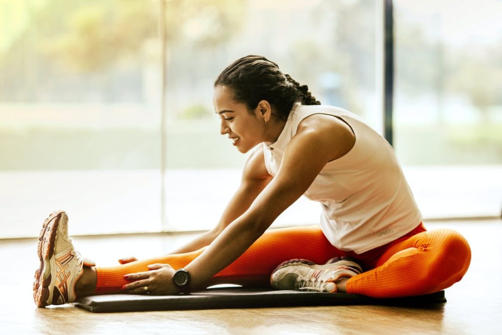  girl stretching for bodyweight strength training